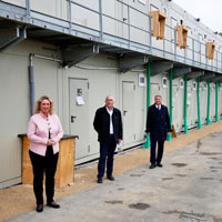 Kerstin Schreyer (Bauministerin), Ewald Weber (Geschäftsführender Gesellschafter Firma Kassecker), Thomas Schmid (Hauptgeschäftsführer Bayerischer Bauindustrieverband e. V.) vor einer Bauarbeiterunterkunft in Donauwörth